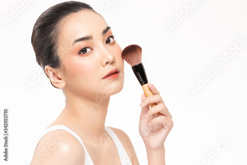 Beauty asian woman brown hair looking smile in camera happiness and hold make up brush and cheerful with make up brush,Beauty Concept on white background.