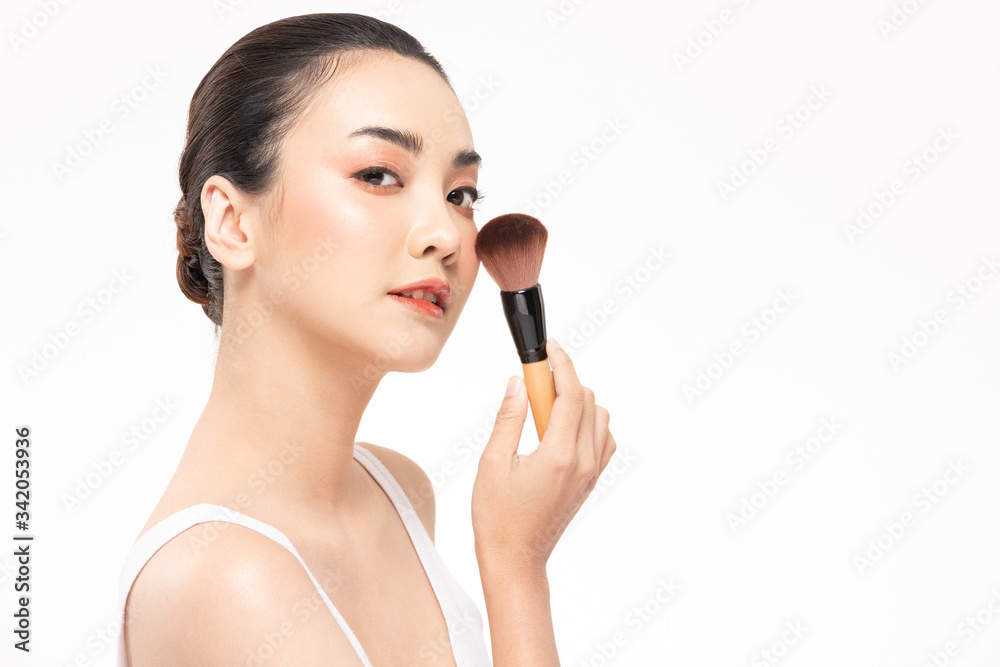 Beauty asian woman brown hair looking smile in camera happiness and hold make up brush and cheerful with make up brush,Beauty Concept on white background. Beauty asian woman brown hair looking smile in camera happiness and hold make up brush and cheerful with make up brush,Beauty Concept on white background.