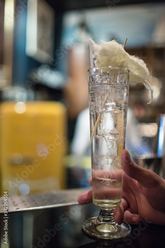 women's hands hold a cocktail