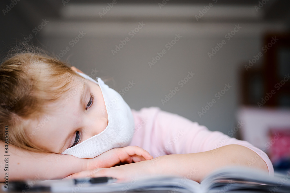 Distance learning online education. Sickness schoolgirl in medical mask and headphones studying at home with digital tablet and doing school homework. Training books and notebooks on table Distance learning online education. Sickness schoolgirl in medical mask and headphones studying at home with digital tablet and doing school homework. Training books and notebooks on table