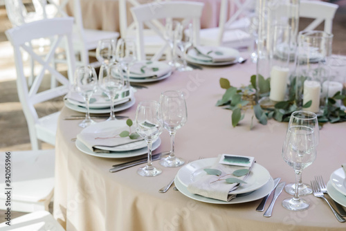 Table setting for party or wedding reception in bright ????, a decoration concept for weddings or social events © Mariia
