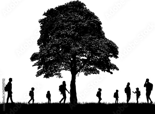Family reaching with backpacks on a trip.
