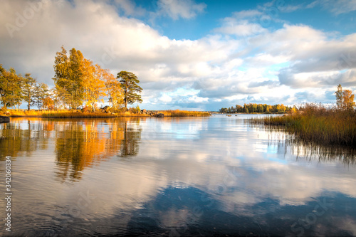 Kotka, Finland - Autumn Park "Sapokka". View on the lake and autumn trees. Refleaction, clouds, calm. Beatiful autumn landscape.