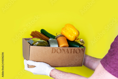 Portrait of delivery man holding parcel standing in front of his van