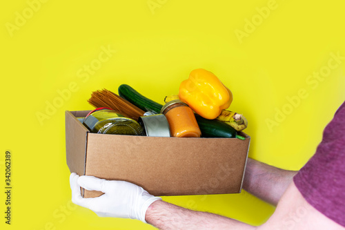 Portrait of delivery man holding parcel standing in front of his van