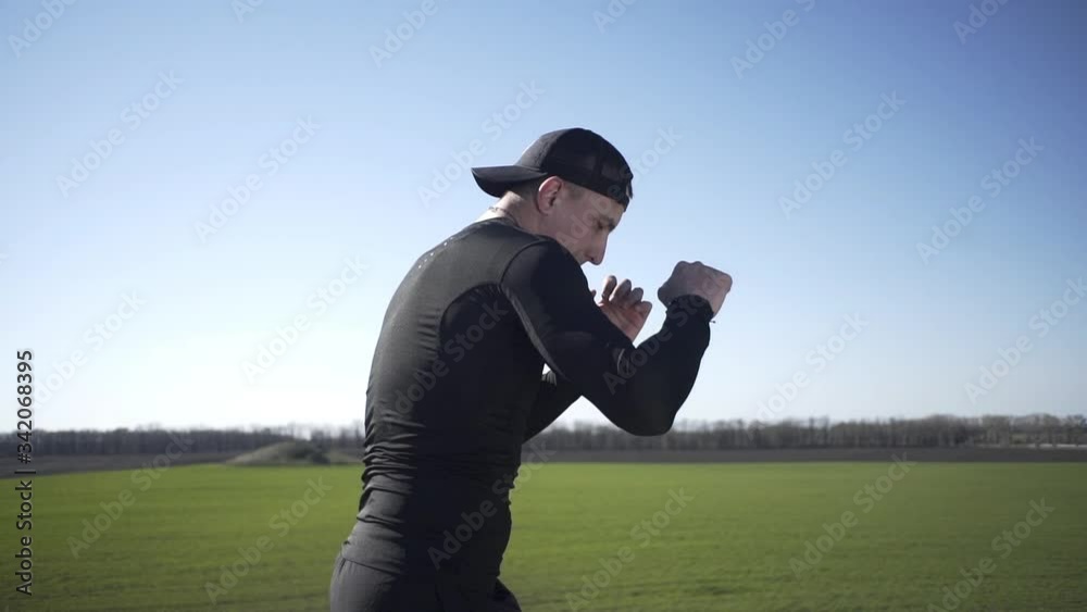 A guy struggles with a shadow in boxing in a field, on a field guy, on an island in a field A guy struggles with a shadow in boxing in a field, on a field guy, on an island in a field