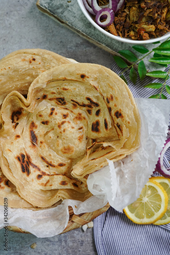 Lachha Paratha or Indian layered Roti with Pork Fry, selective focus photo