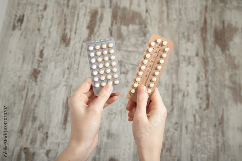 Girl holds birth control pills in her hands. Contraception