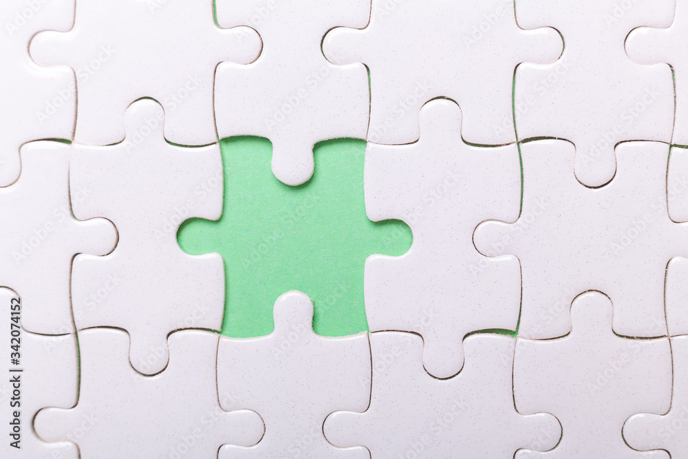 White puzzle background with one piece missing. Close-up. Concept success of business White puzzle background with one piece missing. Close-up. Concept success of business