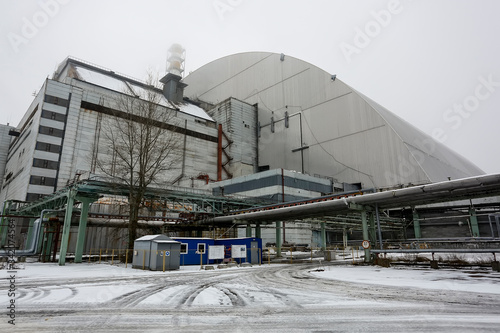 New Safe Confinement above remains of reactor 4 and old sarcophagus at Chernobyl nuclear power plant. Ukraine. photo