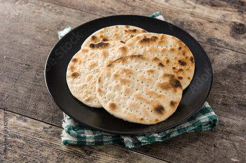 Handmade matzah for Jewish Passover on wooden table photo