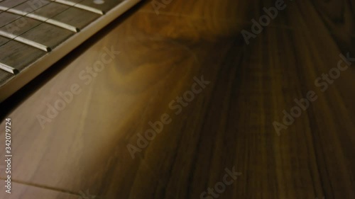A 4K close up shot of a Banjo, guitar, Musical instrument, strings ready to be picked up and played. Learn a new instrument. Learn something new. Panning shot close up