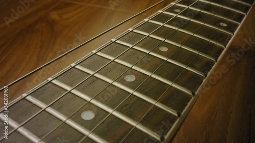 A 4K close up shot of a Banjo, guitar, Musical instrument, strings ready to be picked up and played. Learn a new instrument. Learn something new. Panning shot