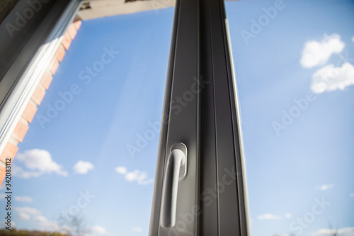 White plastic double glazing window and bright blue sky background