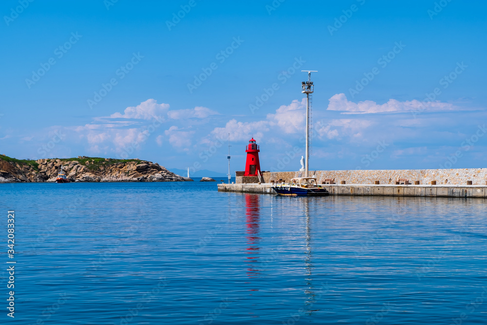View of the red lighthouse in the port of Giglio island (Grosseto, Tuscany, Italy).