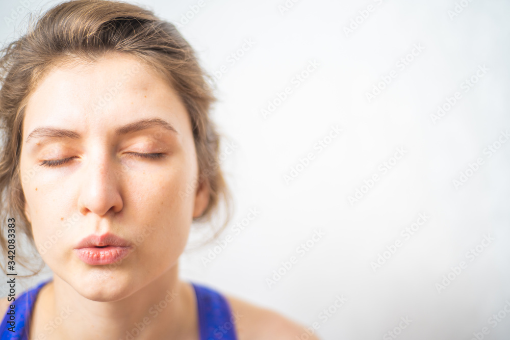 A woman performs breathing exercises during a fitness break. Cleansing the mind and meditation for a healthy mind and body A woman performs breathing exercises during a fitness break. Cleansing the mind and meditation for a healthy mind and body