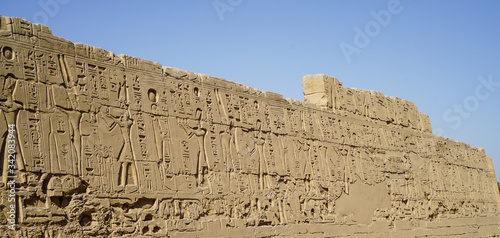 Karnak temple heiroglyphic pharaoh and god carving on stone wall