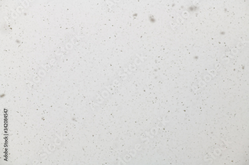 White blurred background with small snowflakes