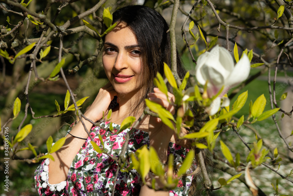 Beautiful middle east girl enjoying spring time with flower dress