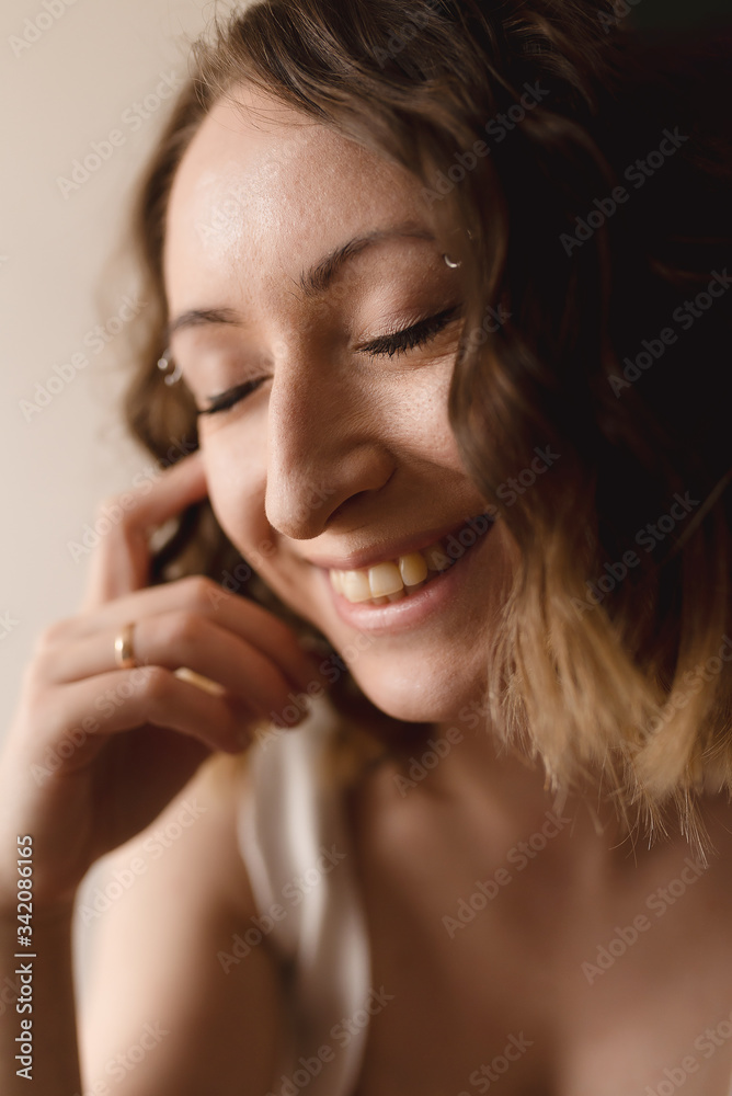 young woman smiling with closed eyes close up young woman smiling with closed eyes close up