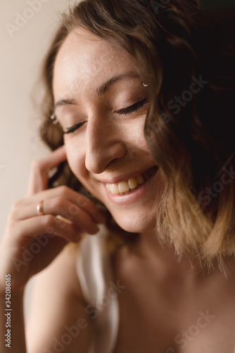 young woman smiling with closed eyes close up