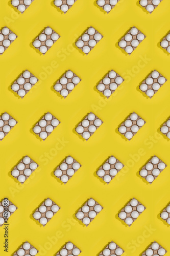 Bright seamless Easter template with white eggs in carton boxes on yellow background photo