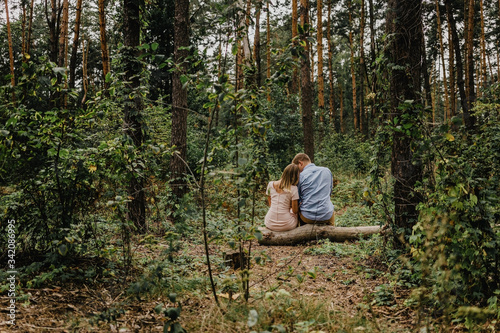Сouple in love sits in the forest