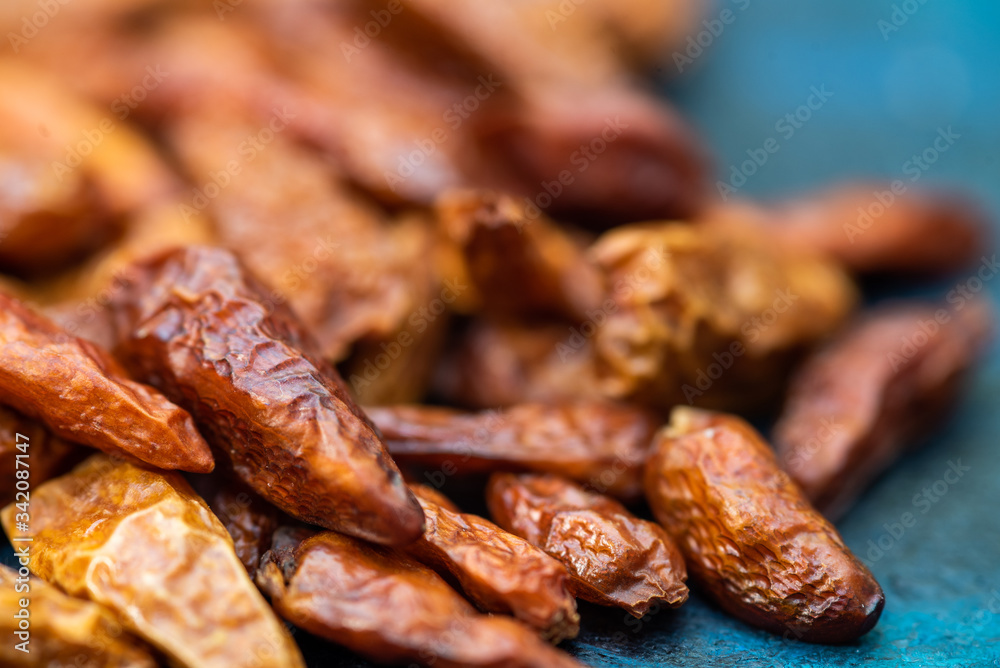 Obraz premium Detail of dried cayenne to add spice to food. Blue dark background