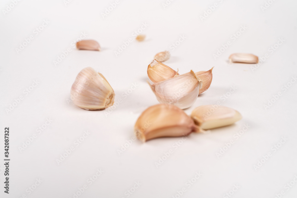 garlic lies on a white table. white background