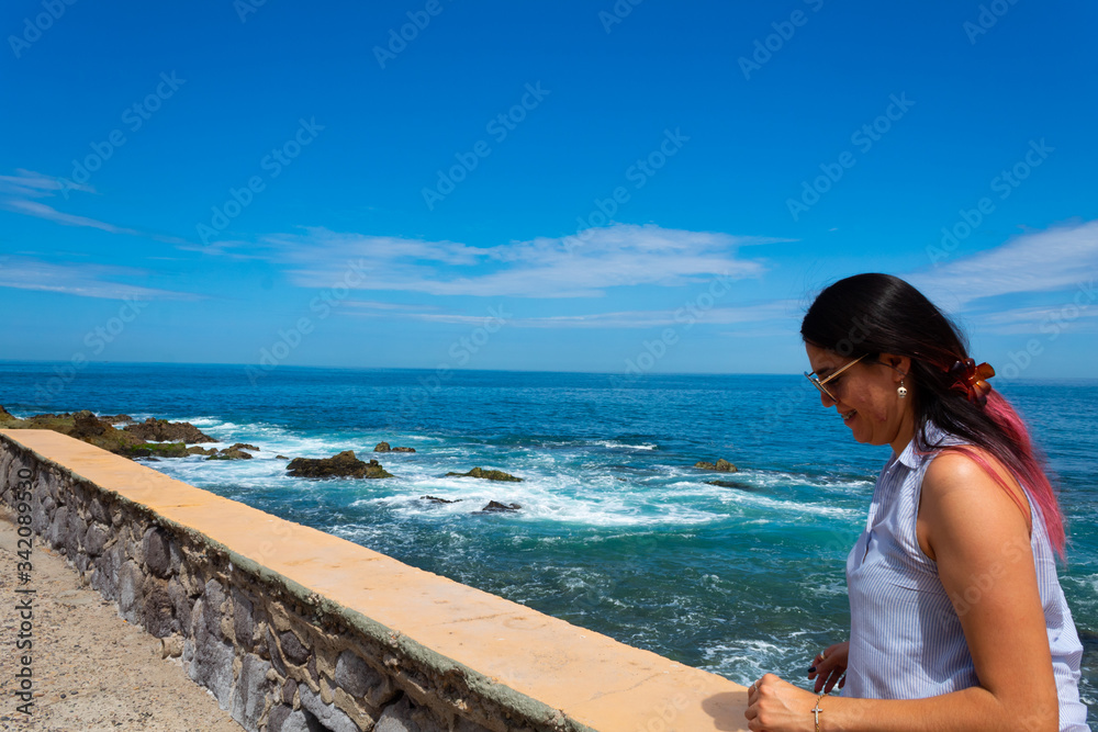 Young Hispanic woman with pink hair enjoying a Mazatlan beach vacation Young Hispanic woman with pink hair enjoying a Mazatlan beach vacation