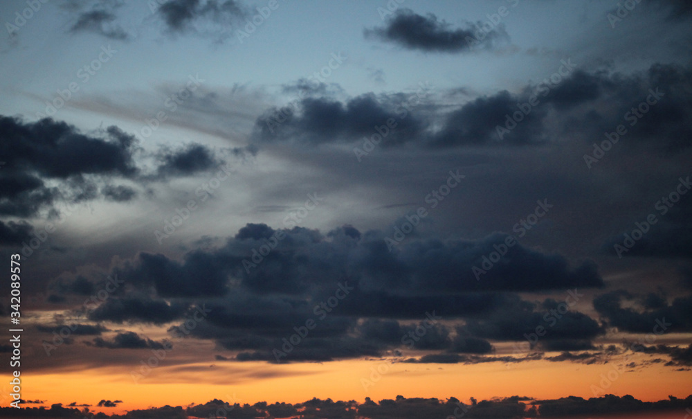 Fototapeta premium Dramatic night sky with clouds. Horizontal nature background..