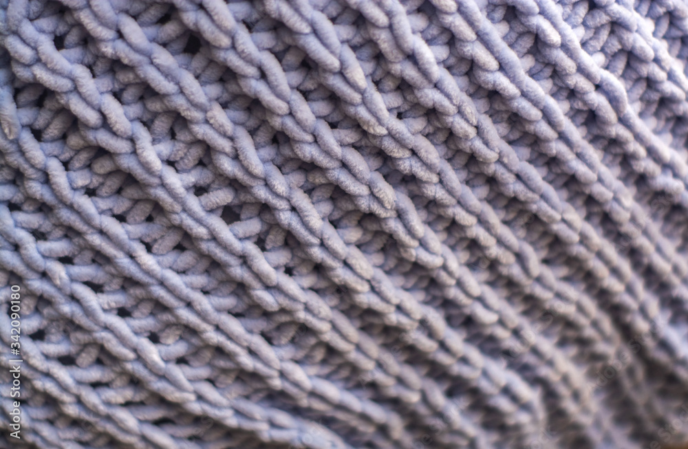 Background or texture of blue hand-knitted plaid and pillows in cosy autumn or winter home. Background or texture of blue hand-knitted plaid and pillows in cosy autumn or winter home.