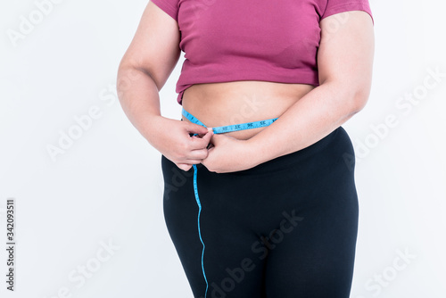 Portrait images of Obese woman use a tape measure Fasten her belly fat On white background, to fat woman and health care concept.