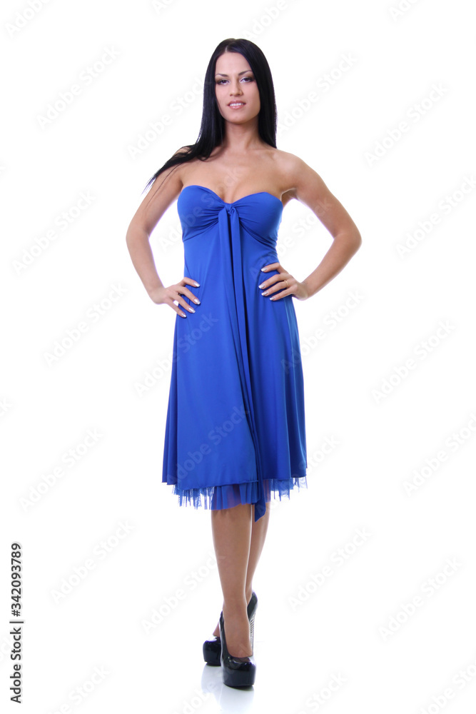 Portrait of a young beautiful brunette woman in blue dress