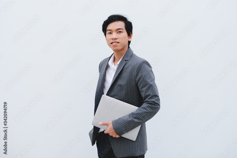 Asia Men Business person  Laptop WFH Gray Background