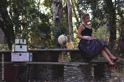 Beautiful girl with vintage clothes in the woods