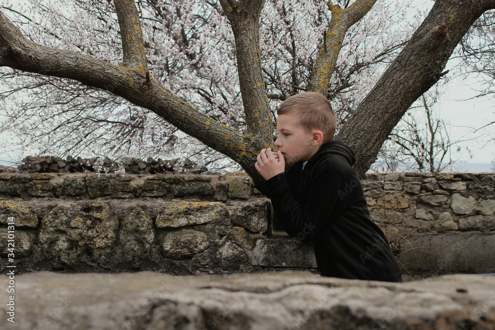 The little boy is standing alone and thoughtful. The little boy is standing alone and thoughtful.