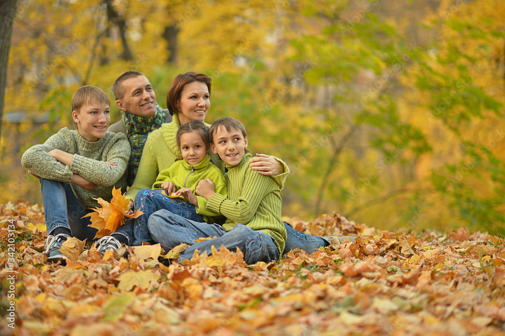 Portrait of family relaxing in autumn park Portrait of family relaxing in autumn park