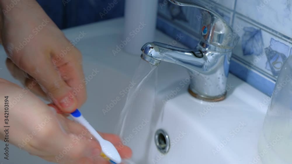 Man is washing hands with antibacterial soap and toothbrush against coronavirus in sink, hands closeup. Infection covid-19 pandemic. Hygienic procedures at home. Obsessive compulsive disorder symptom. Man is washing hands with antibacterial soap and toothbrush against coronavirus in sink, hands closeup. Infection covid-19 pandemic. Hygienic procedures at home. Obsessive compulsive disorder symptom.