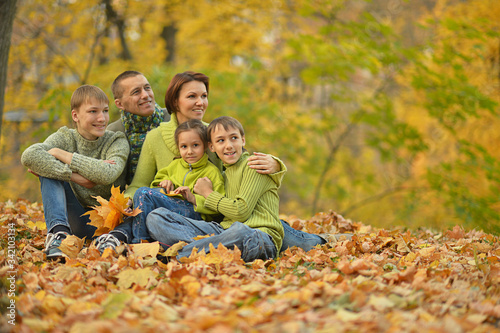 Portrait of family relaxing in autumn park