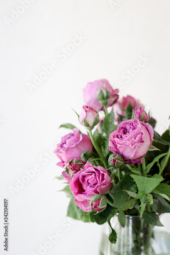 A vase filled with pink rose flowers