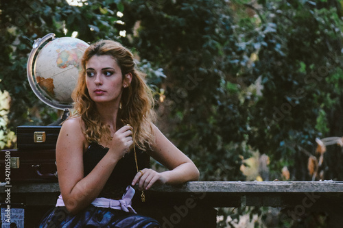 Beautiful girl with vintage clothes in the woods