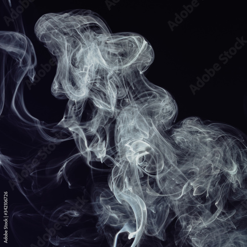Beautiful white smoke on black background. Movement of abstract smoke on dark background © VLADISLAV