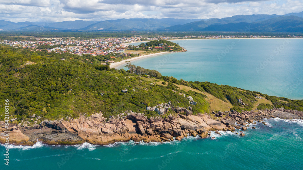 Aerial view of Cima beach, in Palhoça. Beautiful beach among green mountains in Santa Catarina, Brazil
