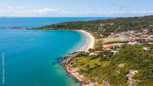 Aerial view of Cima beach, in Palhoça. Beautiful beach among green mountains in Santa Catarina, Brazil © Jair