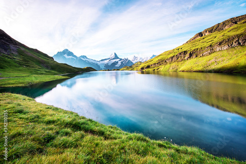Obraz na płótnie Fantastic landscape with the lake in the Swiss Alps. Wetterhorn, Schreckhorn, Finsteraarhorn et Bachsee. exotic places. magical scenes. (relaxation, harmony - concept). w salonie