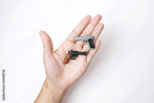Two Tiny Model Pistol and Automatic Gun on Hand in White Background 