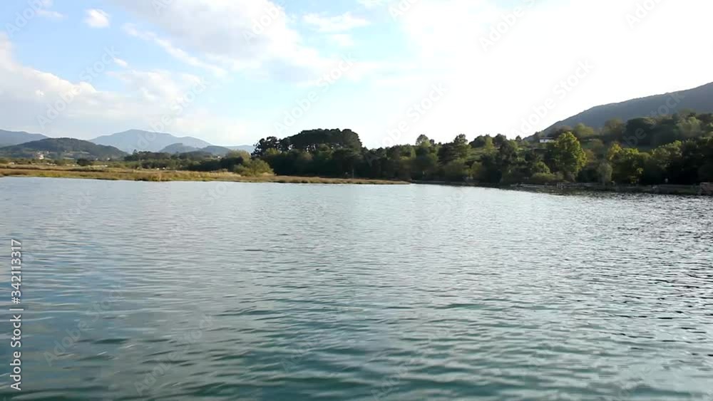 Boat ride in Urdaibai Biosphere Reserve through wide river. Sailing in natural environment. Transportation, leisure concepts Boat ride in Urdaibai Biosphere Reserve through wide river. Sailing in natural environment. Transportation, leisure concepts