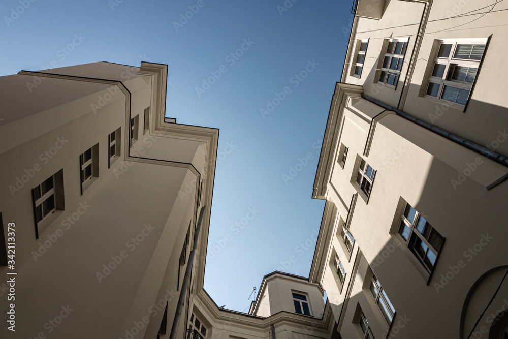 Bottom view of the white townhouse and the blue sky