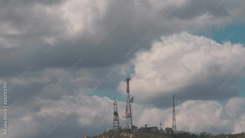 Big TV towers on the mountain and voluminous beautiful clouds Big TV towers on the mountain and voluminous beautiful clouds